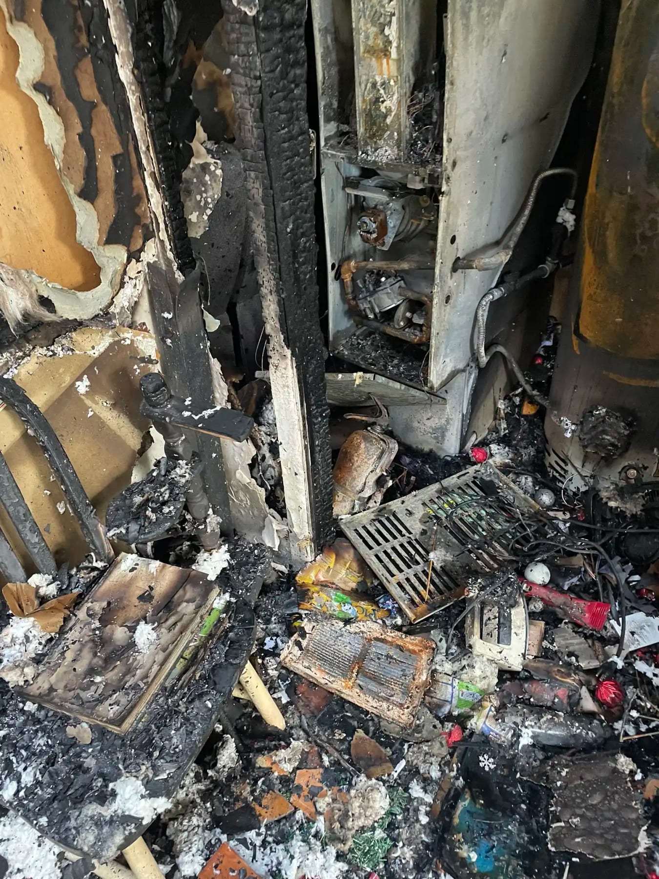 Charred contents and burned belongings piled after a fire