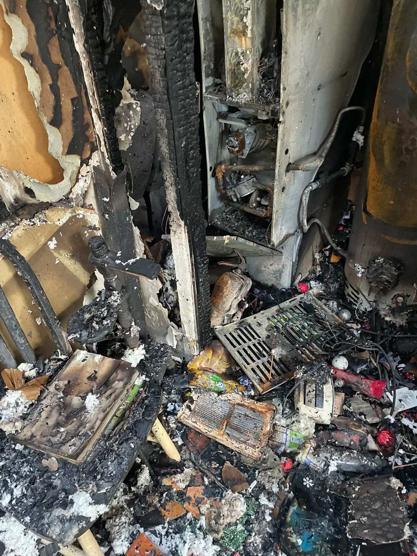 Charred contents and burned belongings piled after a fire